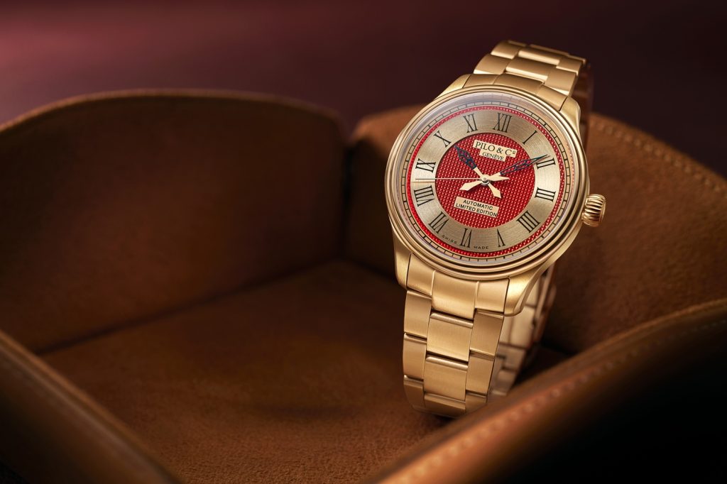 Montre Extraneō rouge et or / Ora Extraneō e kuqe dhe flori